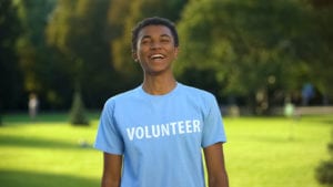 male_teen_volunteer_standing_outside