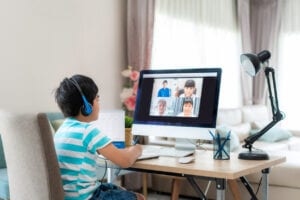 boy student video conferencing with classmates