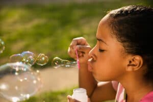 Young Girl Blowing Bubbles