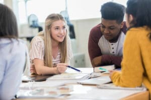 teen-girl-uses-pen-to-make-a-point-with-a-group-of-students