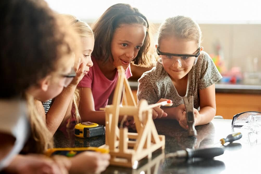young girls playing with a catapult