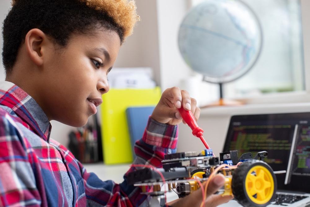 Male student working on robotics car project