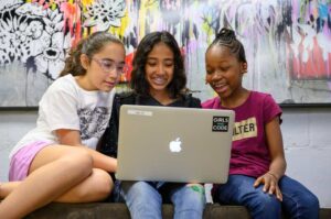 girls who code students working together on laptop