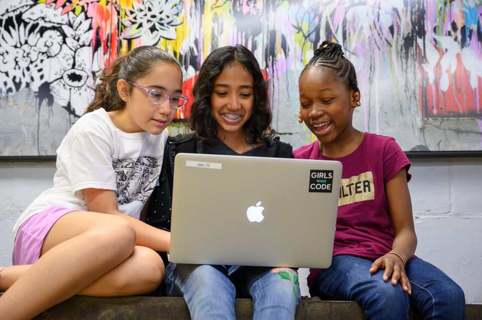 girls who code students working together on laptop
