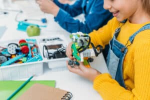schoolgirl building a robot model