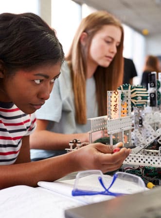 two female students building a machine