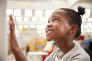 young girl looking at science exhibit