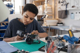 boy works with solder